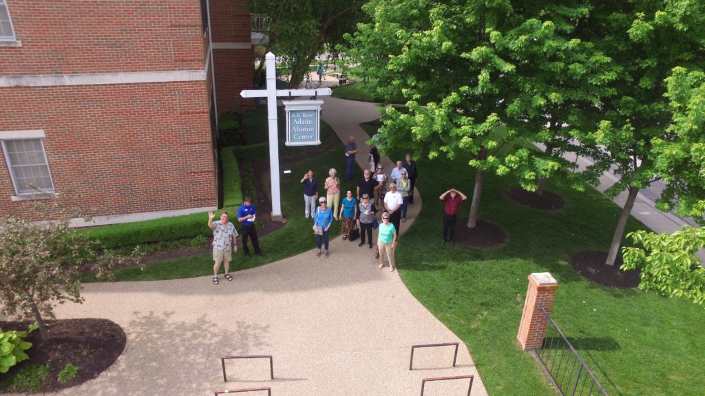 The C&T Studies group watches a drone demonstration outside Adams Alumni Center.